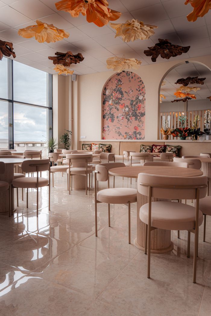 Elegant and modern lounge with stylish floral decor and plush seating in an indoor setting.